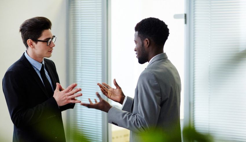 Two businessmen talking in an office.