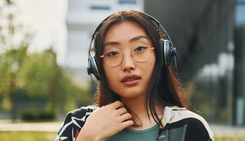 A young asian woman wearing headphones.
