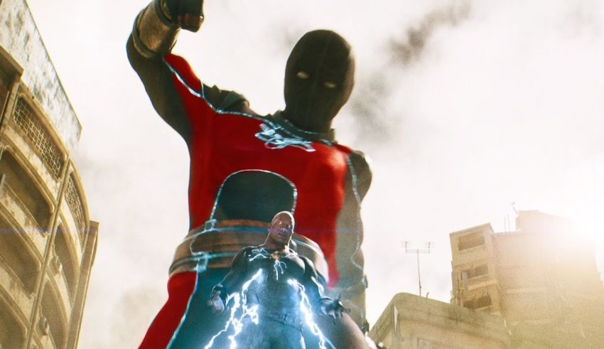 A man in a red suit is standing in front of a city.