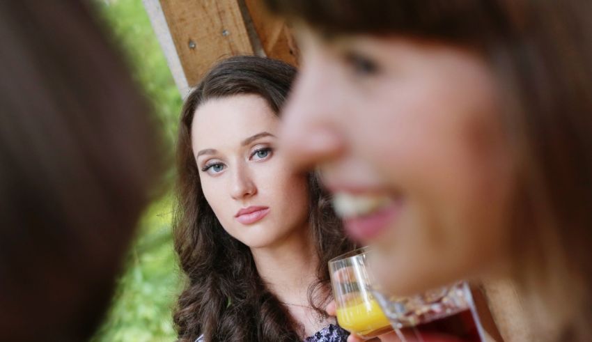 A group of women looking at each other while drinking wine.