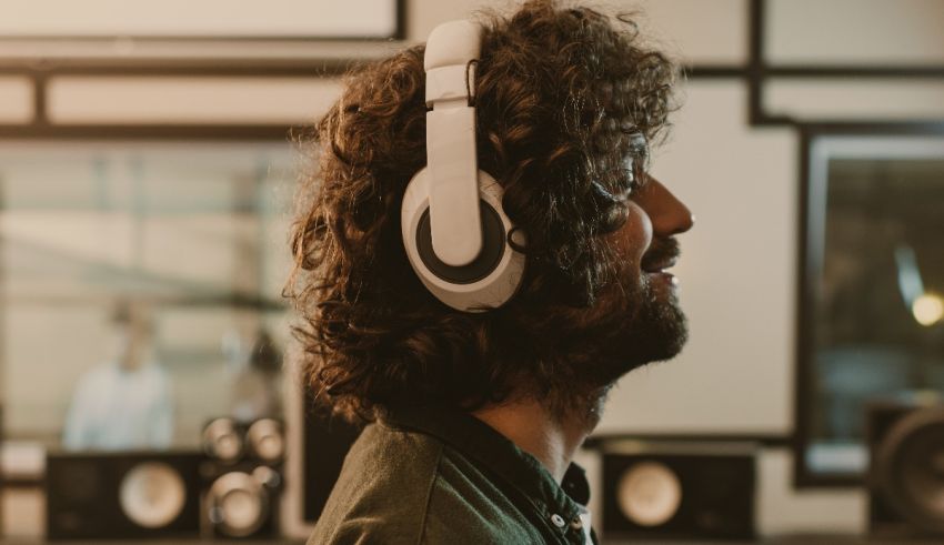A man wearing headphones in a recording studio.
