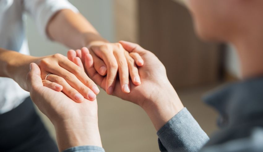 A man and a woman are holding each other's hands.