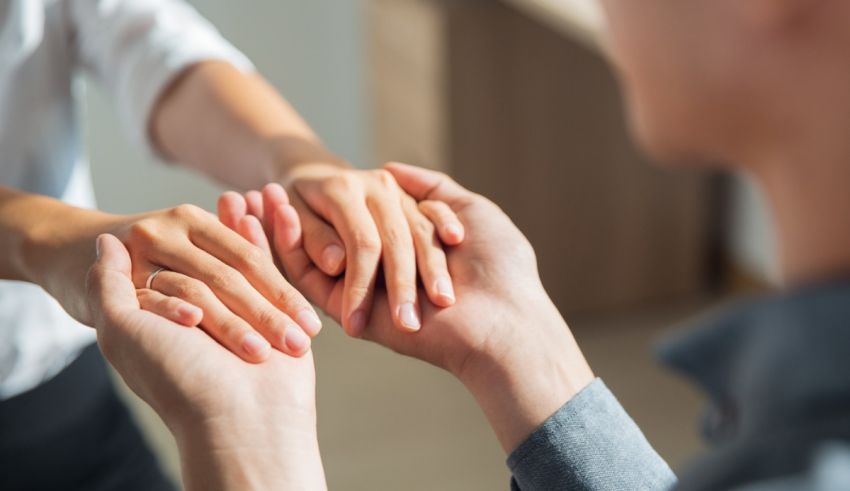 A man and woman holding each other's hands.
