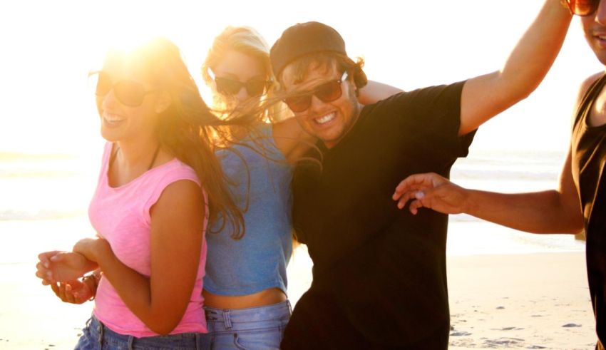 A group of friends dancing on the beach.