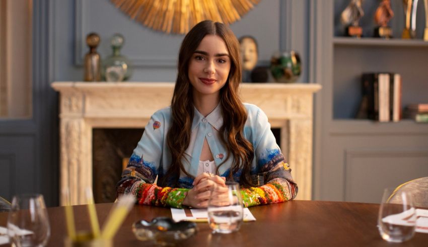 A woman sitting at a table in front of a fireplace.
