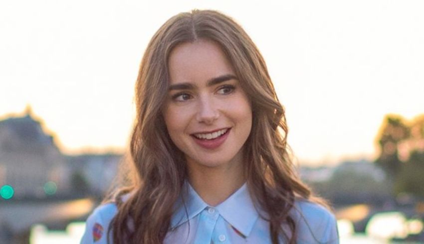 A young woman smiling in front of a city.
