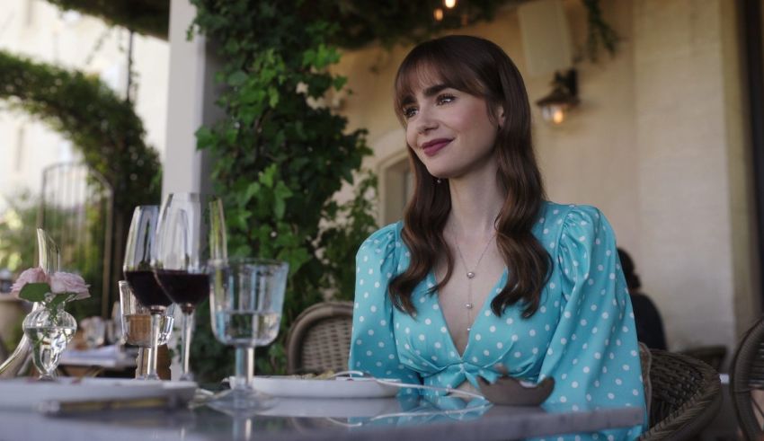 A woman in a polka dot dress sitting at a table.
