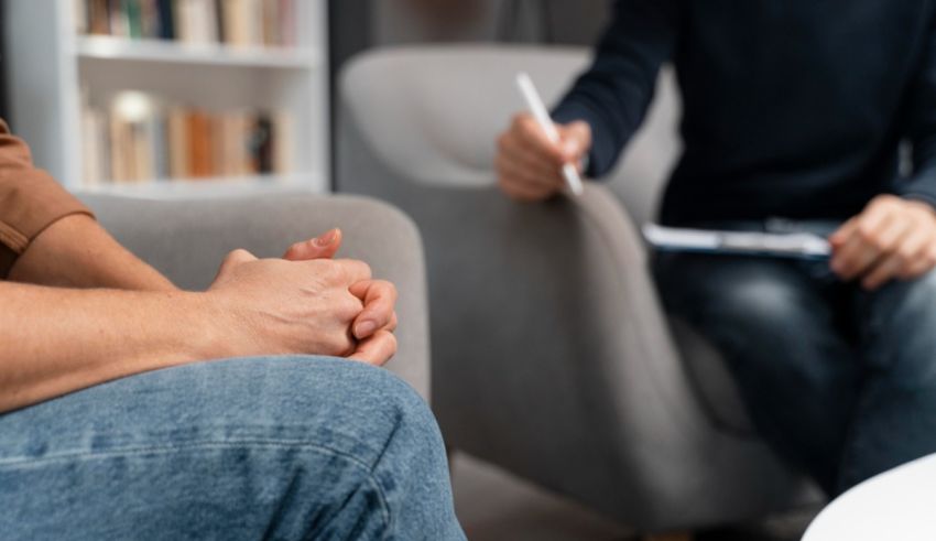 Two people sitting in a chair and talking to each other.