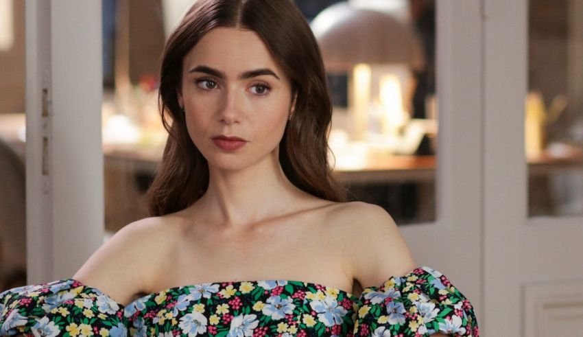 A woman in a floral dress is posing for a photo.
