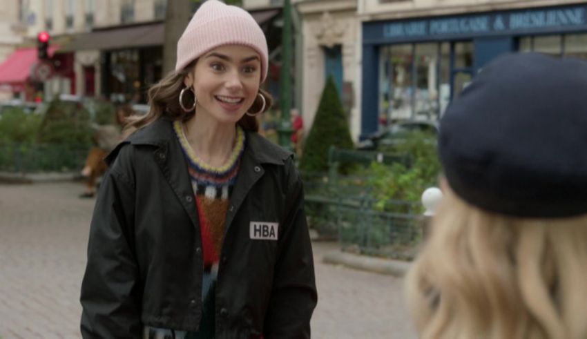 A woman is talking to another woman on the street.