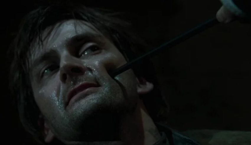 A man with a knife in his mouth.