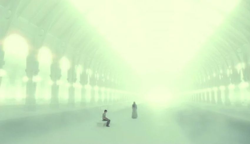 Two people standing in a hallway with a light shining on them.