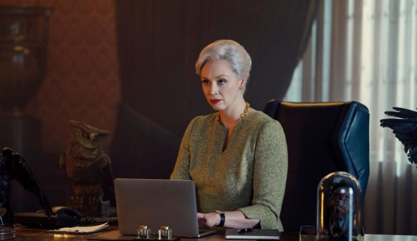 A woman sitting at a desk with a laptop.