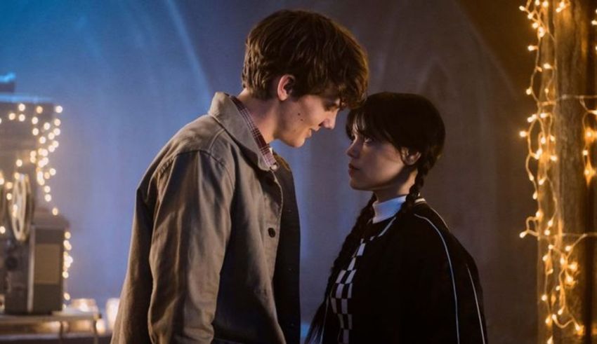 A man and a woman standing next to each other in a dark room.