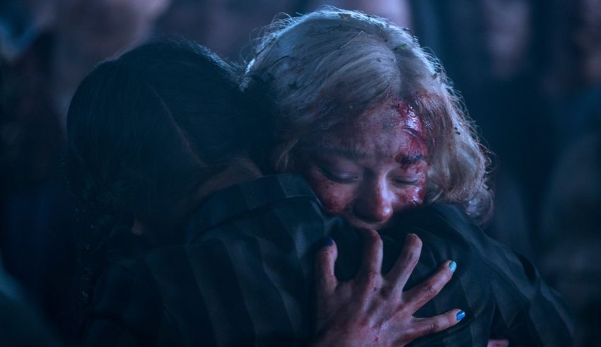 Two women hugging each other in a dark room.