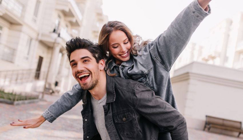 A young man and woman are having a good time on a city street.