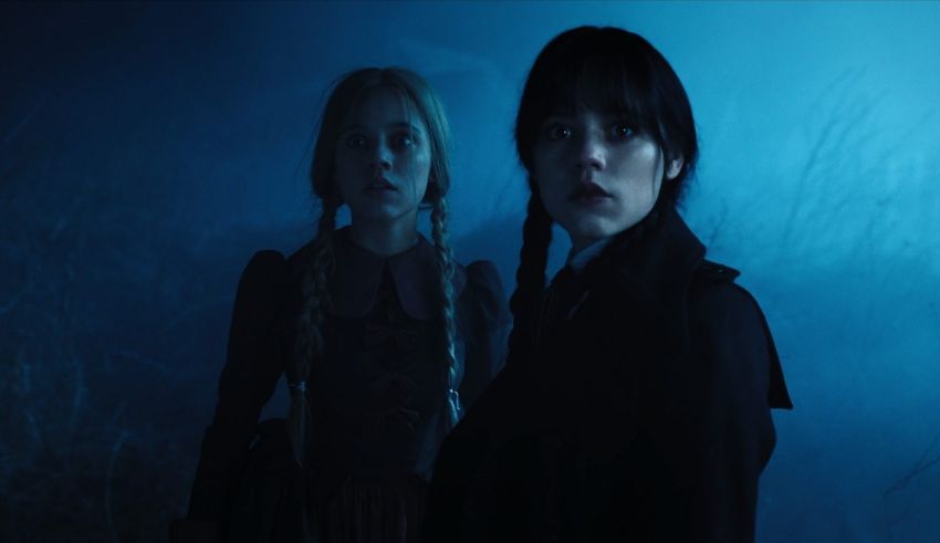 Two young women standing in a dark forest.