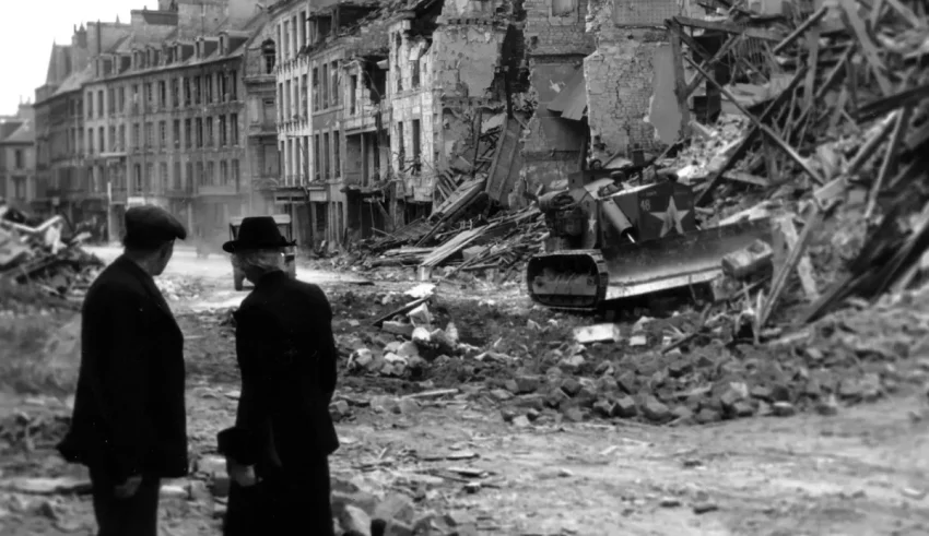 Two men standing in the middle of a destroyed city.