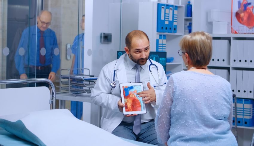 A doctor is talking to a patient in a hospital room.