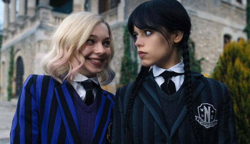 Two girls in school uniforms standing next to each other.
