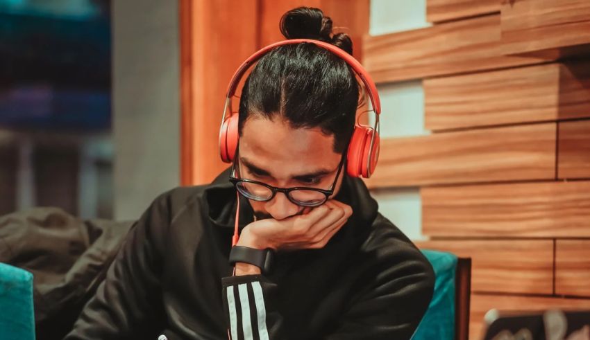 A man sitting in a chair with headphones on.