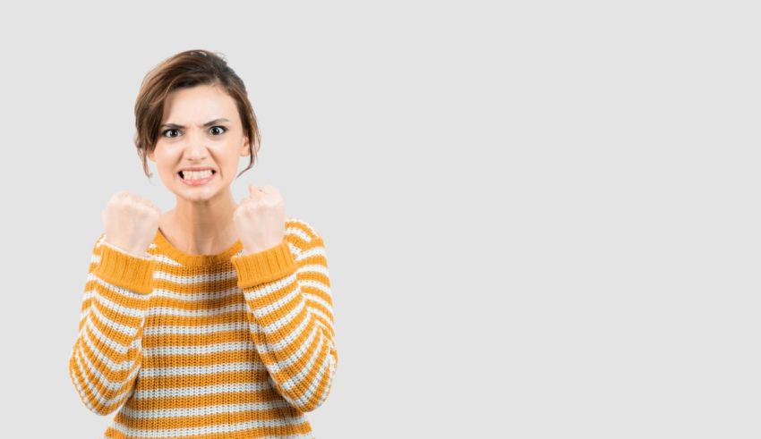 A woman yelling with her fists up.