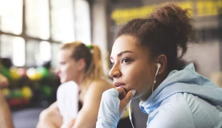 A group of women listening to music in a gym.