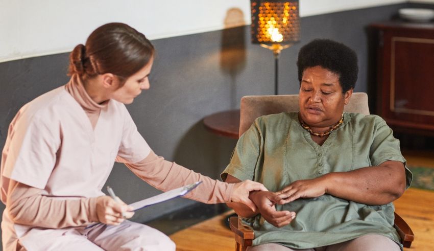 A nurse is talking to a woman in a chair.