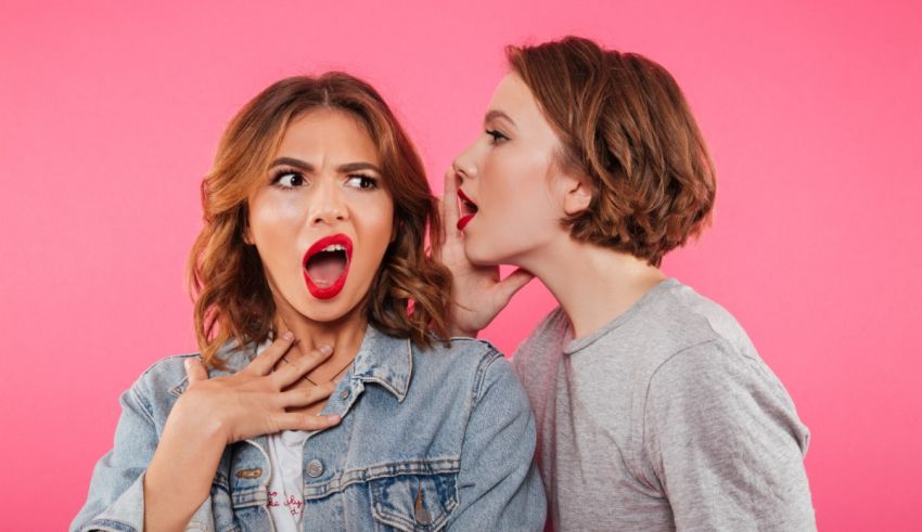 A woman is yelling at a man in front of a pink background.