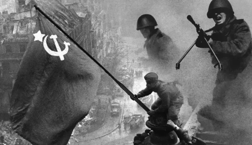 A group of soldiers with a communist flag on top of a building.