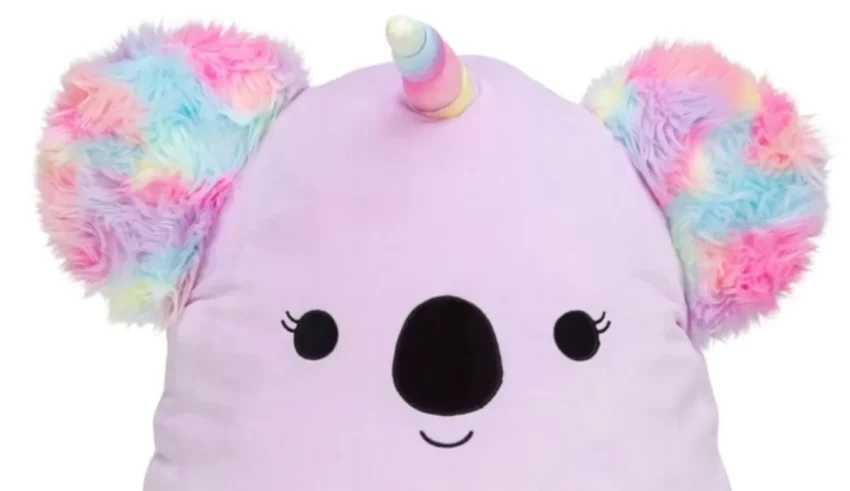 A koala stuffed animal with rainbow horns.