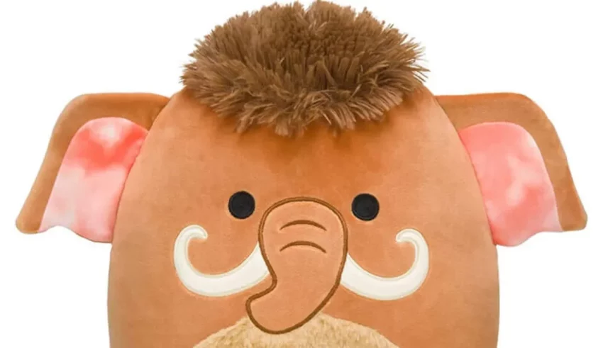 An elephant stuffed animal with a tusk on its head.
