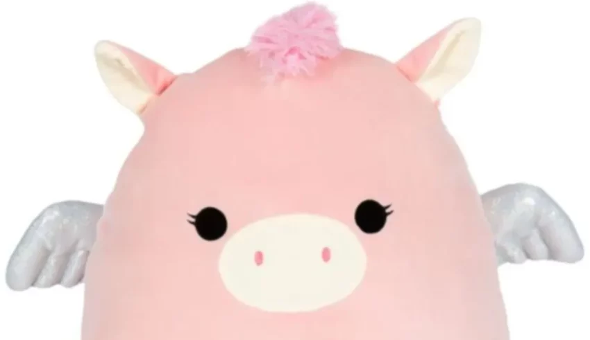 A pink unicorn stuffed animal with wings.