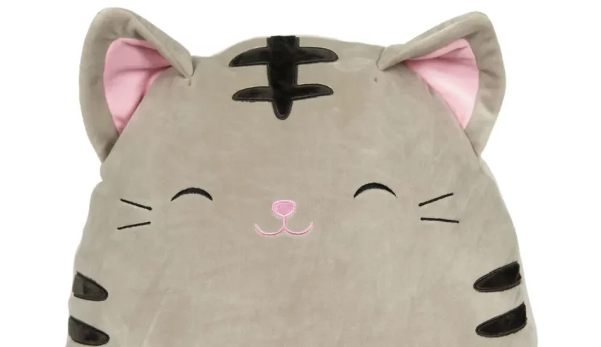 A gray cat stuffed animal with pink eyes.