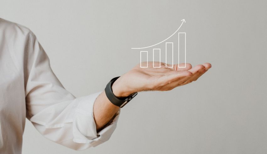 A businessman holding a growth chart in his hand.