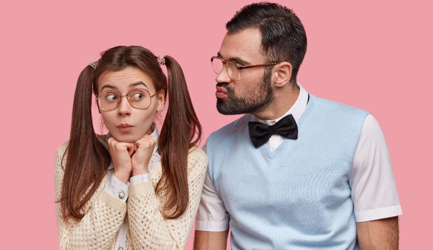 A man and woman in glasses are looking at each other.