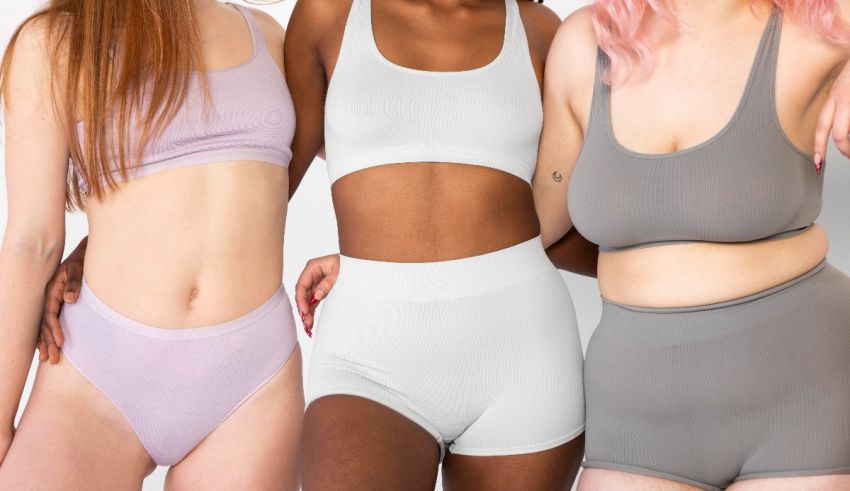 Three women are posing for a photo in their underwear.