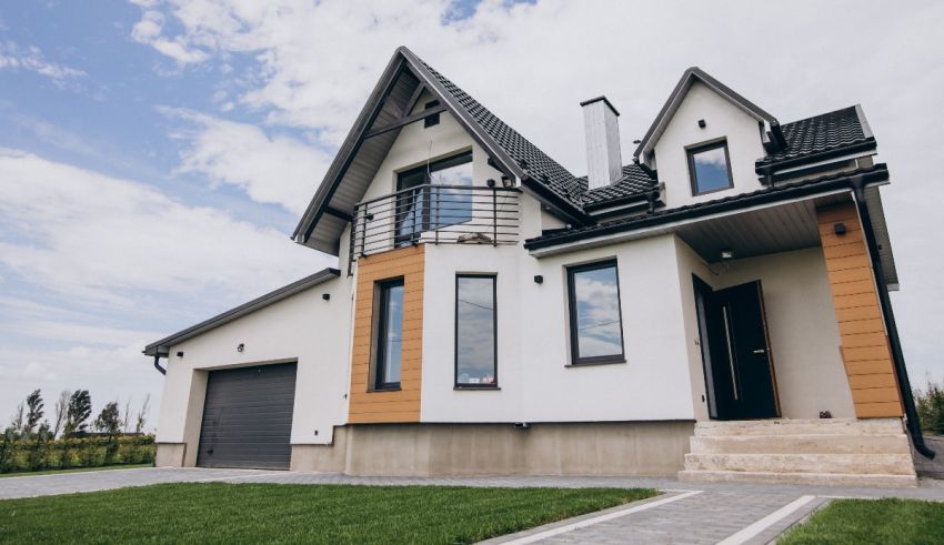 A modern house with a garage and grass.