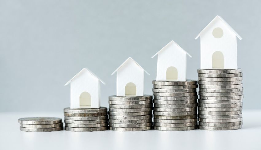 A stack of coins with house models on top.