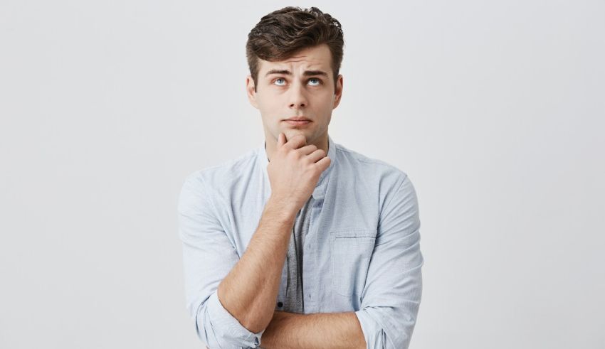 A young man with his hand on his chin.