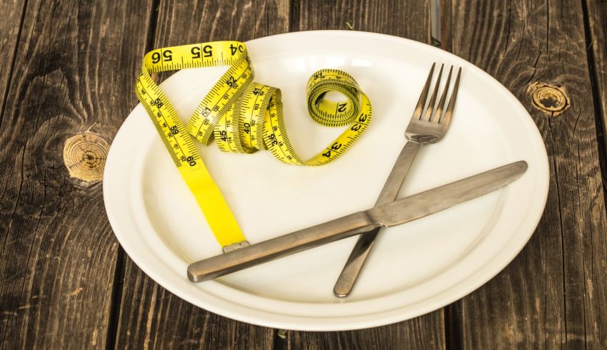 A plate with a knife and measuring tape on it.