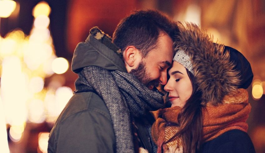 A man and woman hugging in a city at night.