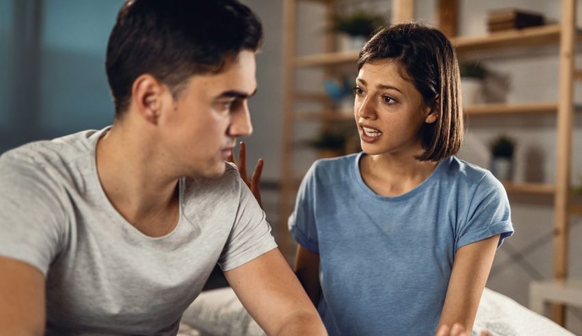 A man and a woman talking on the bed.