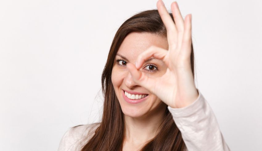 A woman is making an ok sign with her hand.