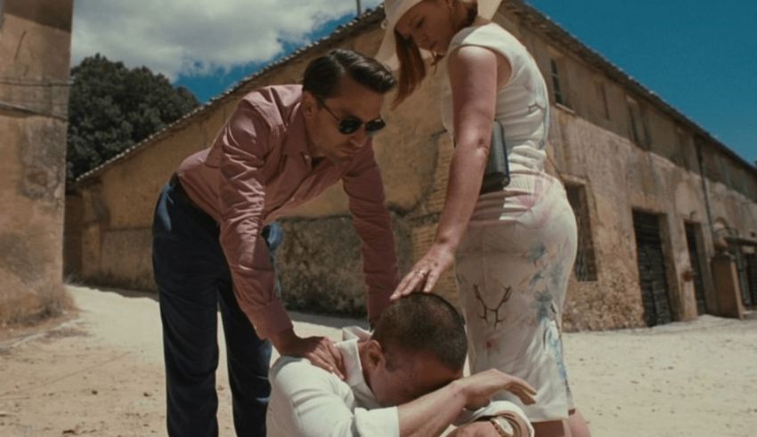 A man is helping a woman on the ground.