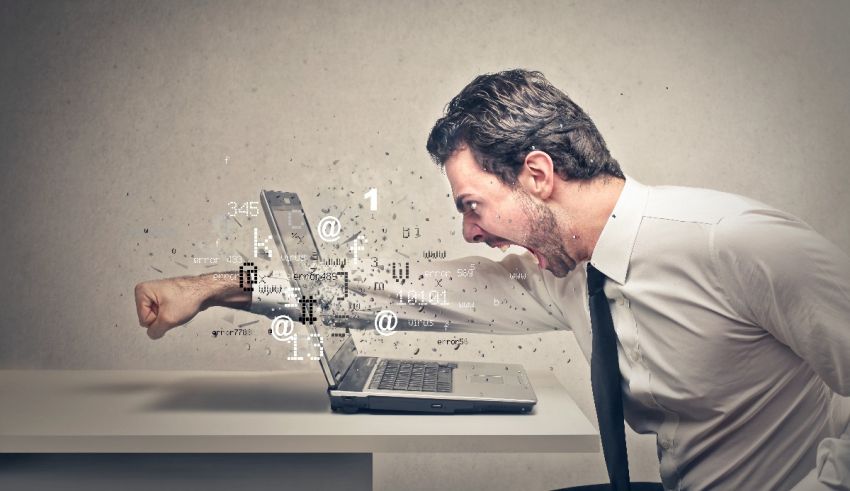 A man is yelling at a computer screen.