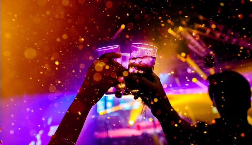 Two people toasting at a nightclub.