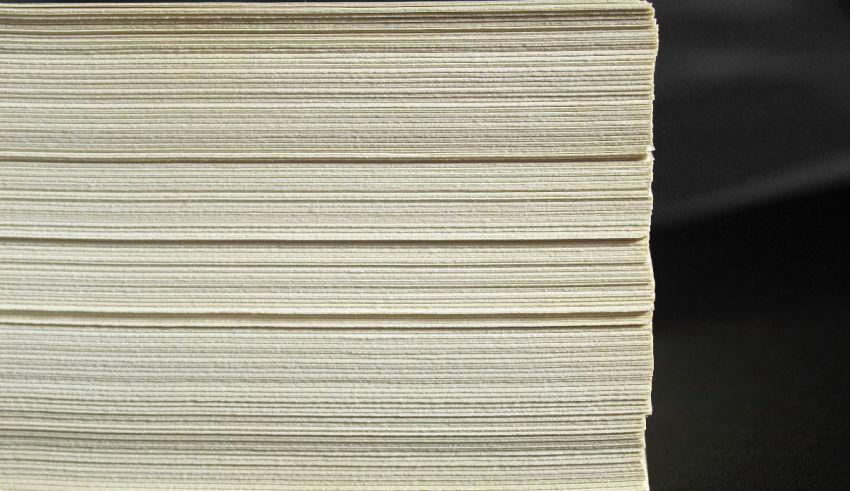 A stack of white paper on a black surface.