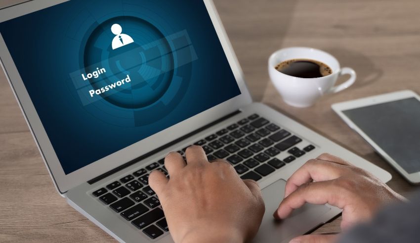 A person typing on a laptop with a digital password on it.