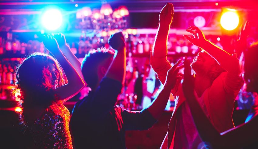 A group of people dancing at a nightclub.